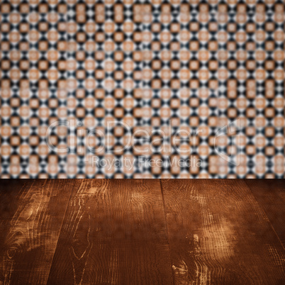 Wood table top and blur vintage ceramic tile pattern wall