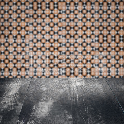 Wood table top and blur vintage ceramic tile pattern wall