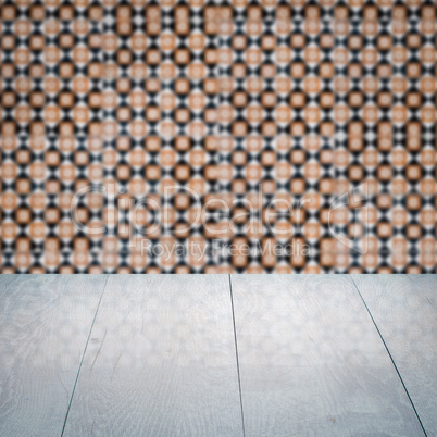 Wood table top and blur vintage ceramic tile pattern wall