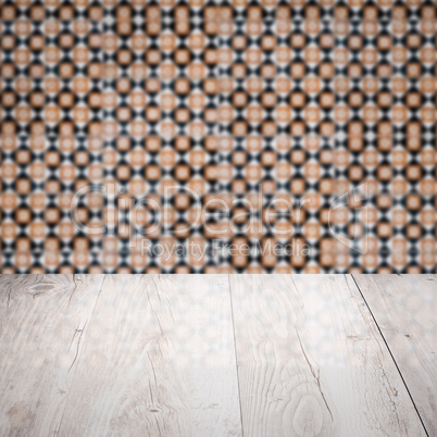 Wood table top and blur vintage ceramic tile pattern wall