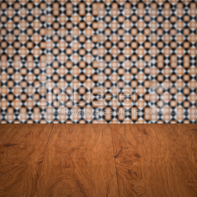 Wood table top and blur vintage ceramic tile pattern wall