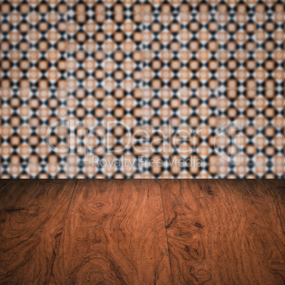 Wood table top and blur vintage ceramic tile pattern wall Wood table top and blur vintage ceramic tile pattern wall