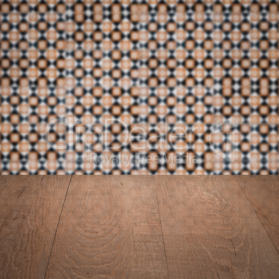 Wood table top and blur vintage ceramic tile pattern wall