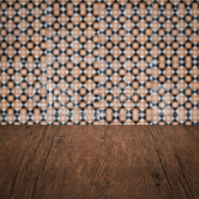 Wood table top and blur vintage ceramic tile pattern wall