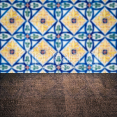 Wood table top and blur vintage ceramic tile pattern wall