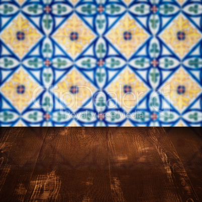 Wood table top and blur vintage ceramic tile pattern wall