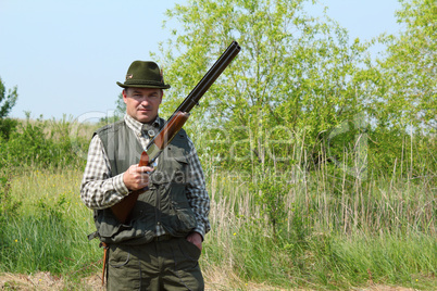 hunter posing with shotgun