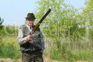 hunter posing with shotgun