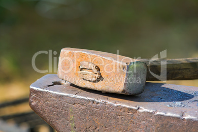 Hammer and anvil for forging metal