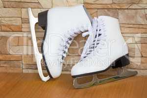 The female skates and boots of white color for figure skating.