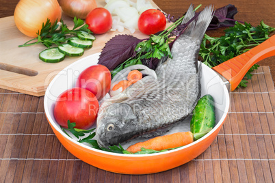 Fish and components for her preparation: vegetables, spices, par