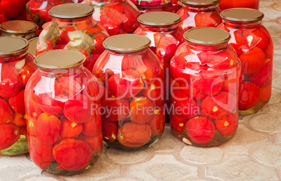 Tinned tomatoes in big glass jars.