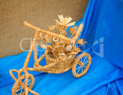 The original souvenir made of wattled straw against blue silk.