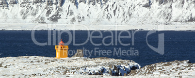 Wide shot panorama of an orange lighthouse, Iceland