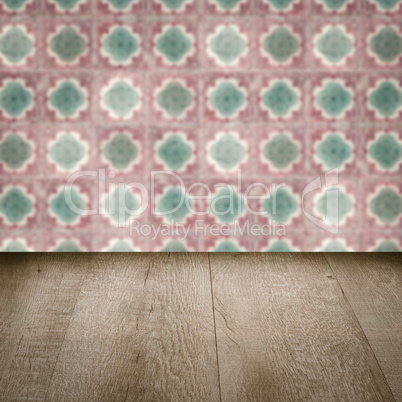 Wood table top and blur vintage ceramic tile pattern wall