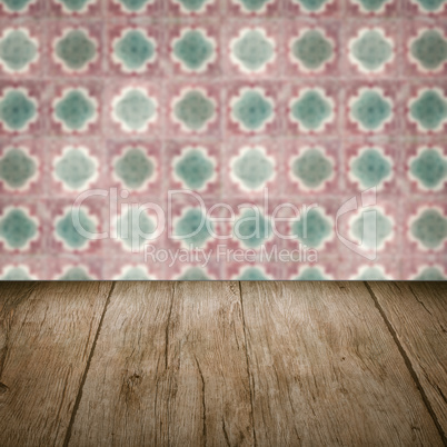 Wood table top and blur vintage ceramic tile pattern wall