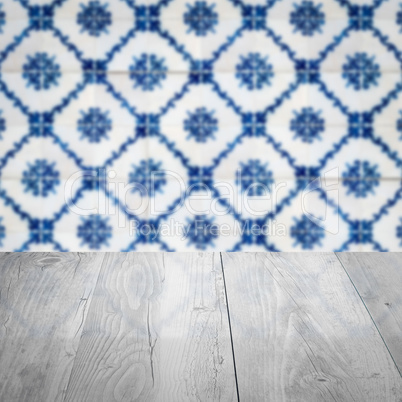 Wood table top and blur vintage ceramic tile pattern wall