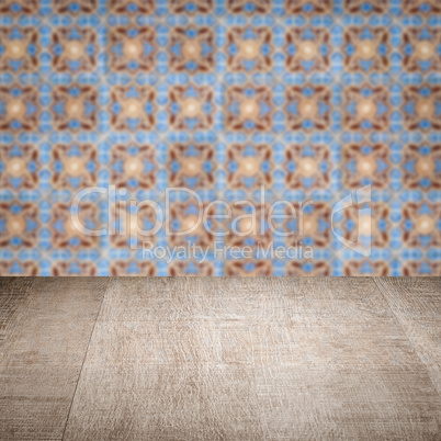 Wood table top and blur vintage ceramic tile pattern wall