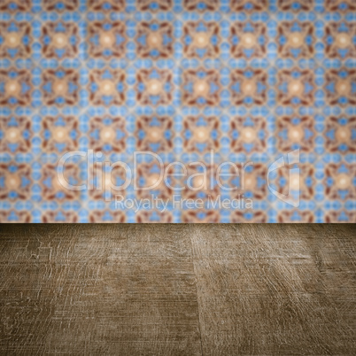 Wood table top and blur vintage ceramic tile pattern wall