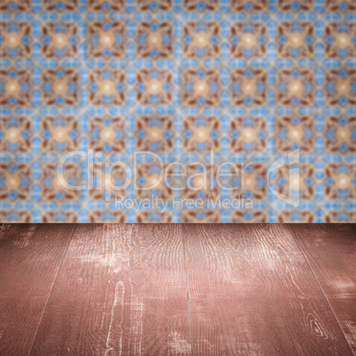 Wood table top and blur vintage ceramic tile pattern wall