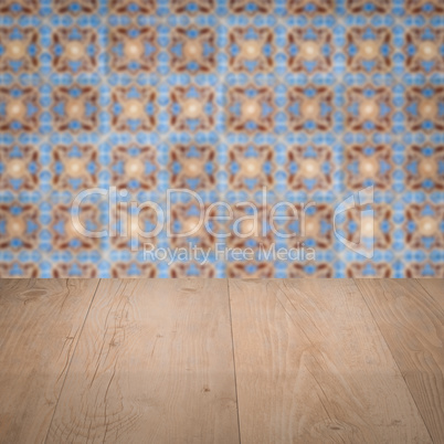 Wood table top and blur vintage ceramic tile pattern wall