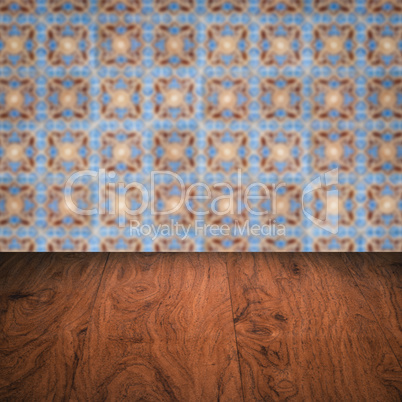 Wood table top and blur vintage ceramic tile pattern wall