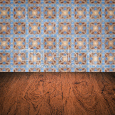Wood table top and blur vintage ceramic tile pattern wall Wood table top and blur vintage ceramic tile pattern wall