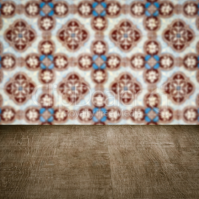 Wood table top and blur vintage ceramic tile pattern wall