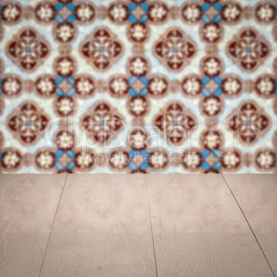 Wood table top and blur vintage ceramic tile pattern wall Wood table top and blur vintage ceramic tile pattern wall