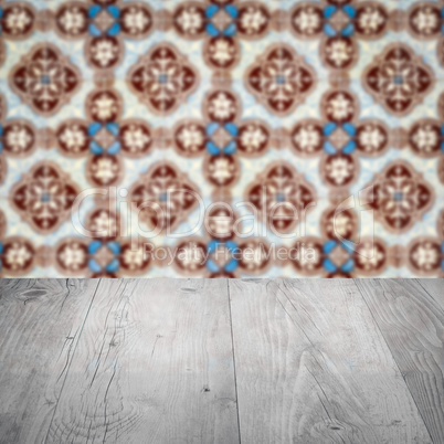 Wood table top and blur vintage ceramic tile pattern wall