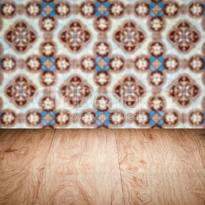 Wood table top and blur vintage ceramic tile pattern wall