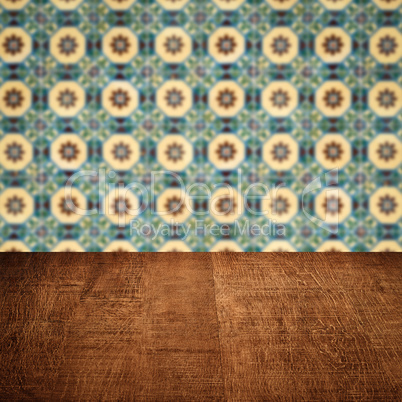 Wood table top and blur vintage ceramic tile pattern wall