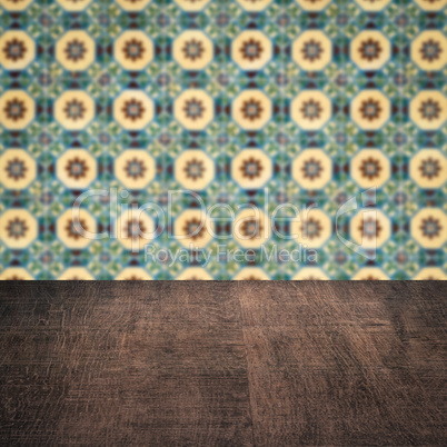 Wood table top and blur vintage ceramic tile pattern wall