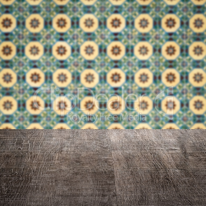 Wood table top and blur vintage ceramic tile pattern wall