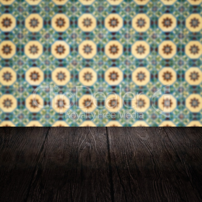 Wood table top and blur vintage ceramic tile pattern wall Wood table top and blur vintage ceramic tile pattern wall