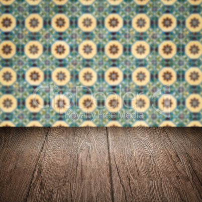 Wood table top and blur vintage ceramic tile pattern wall