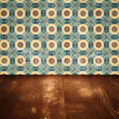 Wood table top and blur vintage ceramic tile pattern wall