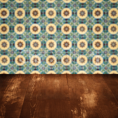 Wood table top and blur vintage ceramic tile pattern wall