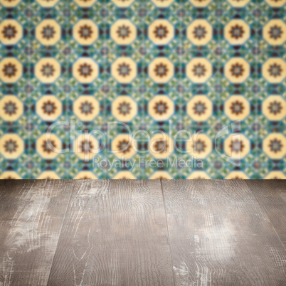 Wood table top and blur vintage ceramic tile pattern wall