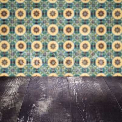 Wood table top and blur vintage ceramic tile pattern wall