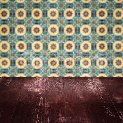 Wood table top and blur vintage ceramic tile pattern wall Wood table top and blur vintage ceramic tile pattern wall