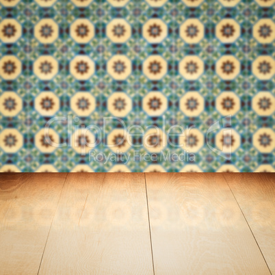 Wood table top and blur vintage ceramic tile pattern wall