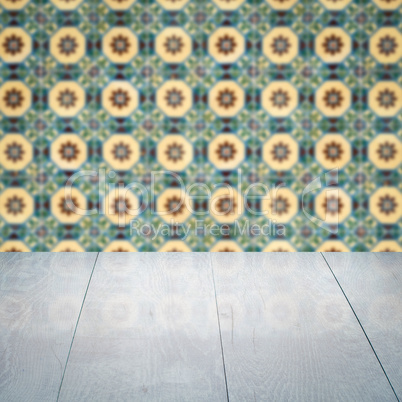 Wood table top and blur vintage ceramic tile pattern wall