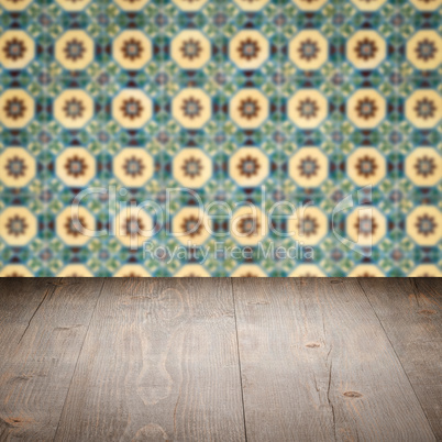 Wood table top and blur vintage ceramic tile pattern wall