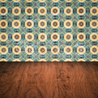 Wood table top and blur vintage ceramic tile pattern wall