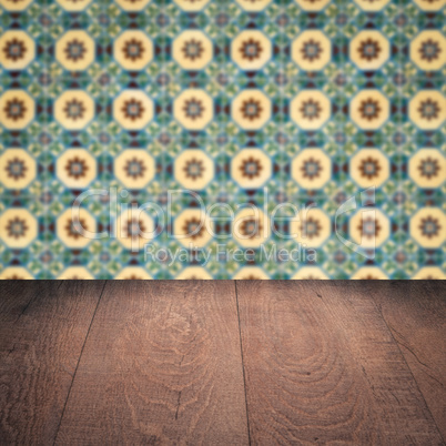 Wood table top and blur vintage ceramic tile pattern wall