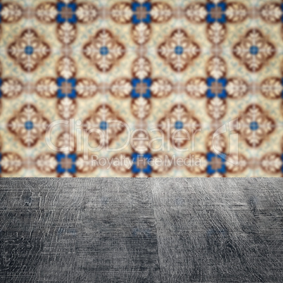 Wood table top and blur vintage ceramic tile pattern wall