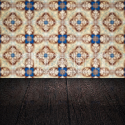 Wood table top and blur vintage ceramic tile pattern wall