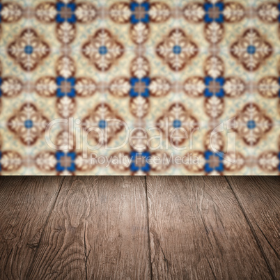 Wood table top and blur vintage ceramic tile pattern wall