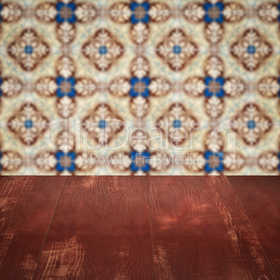 Wood table top and blur vintage ceramic tile pattern wall